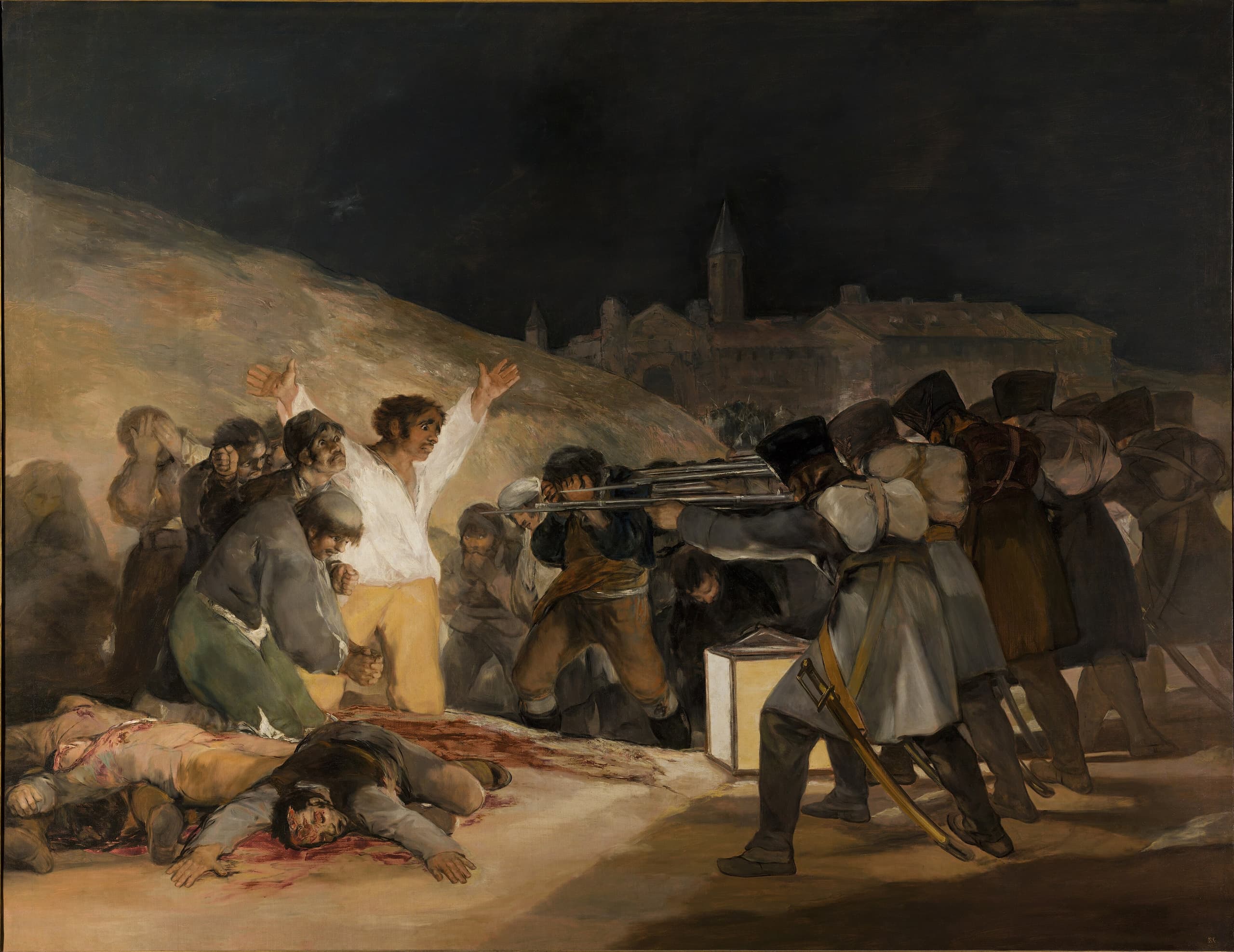 A man in a white shirt kneels with his arms spread wide, facing a line of soldiers aiming rifles. A lantern on the ground casts light on him. Bodies lie to his left; other prisoners wait to his right.
