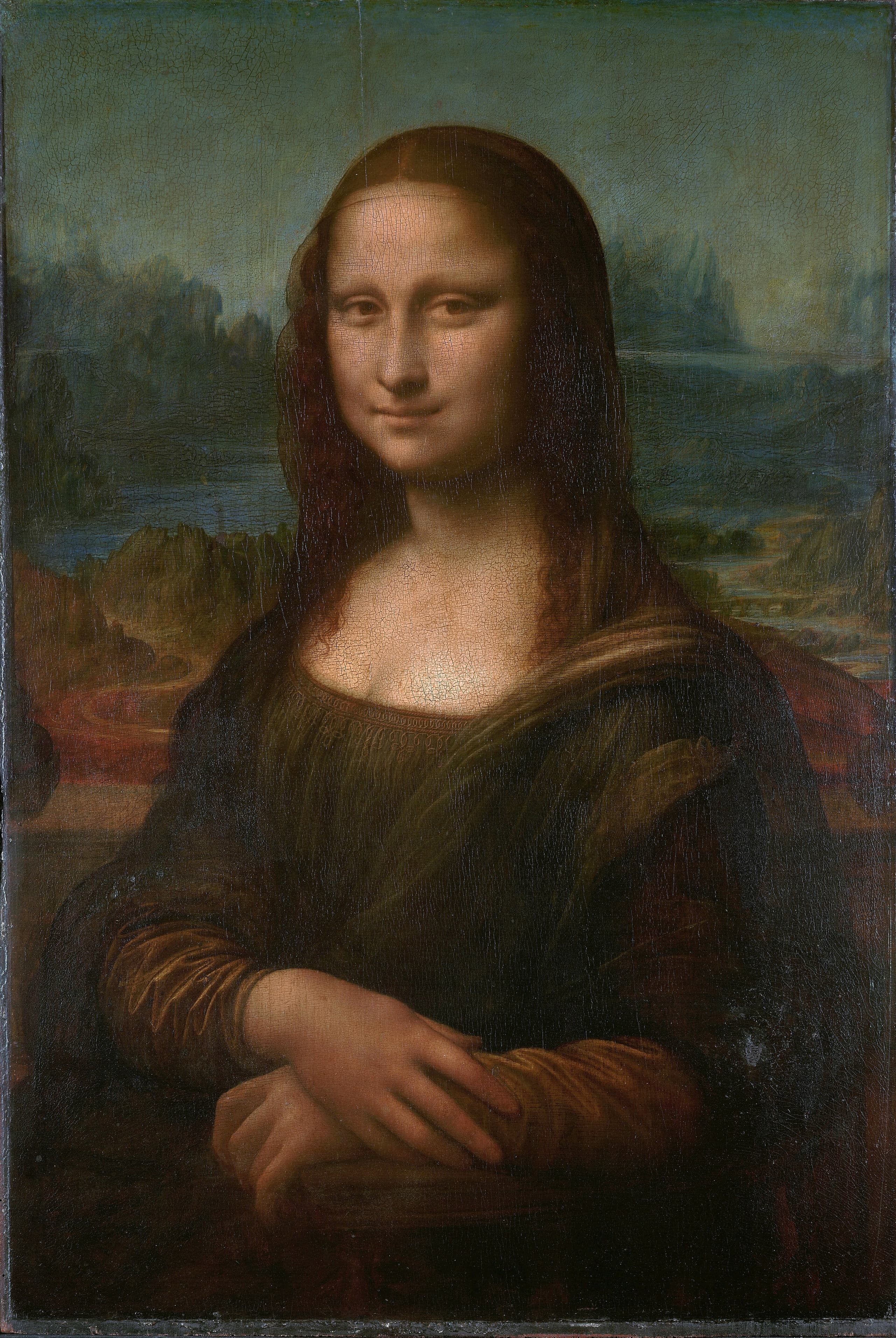 A woman in dark clothing with her hands folded, seated before a distant landscape of winding roads, water, and rocky outcrops under a hazy sky.
