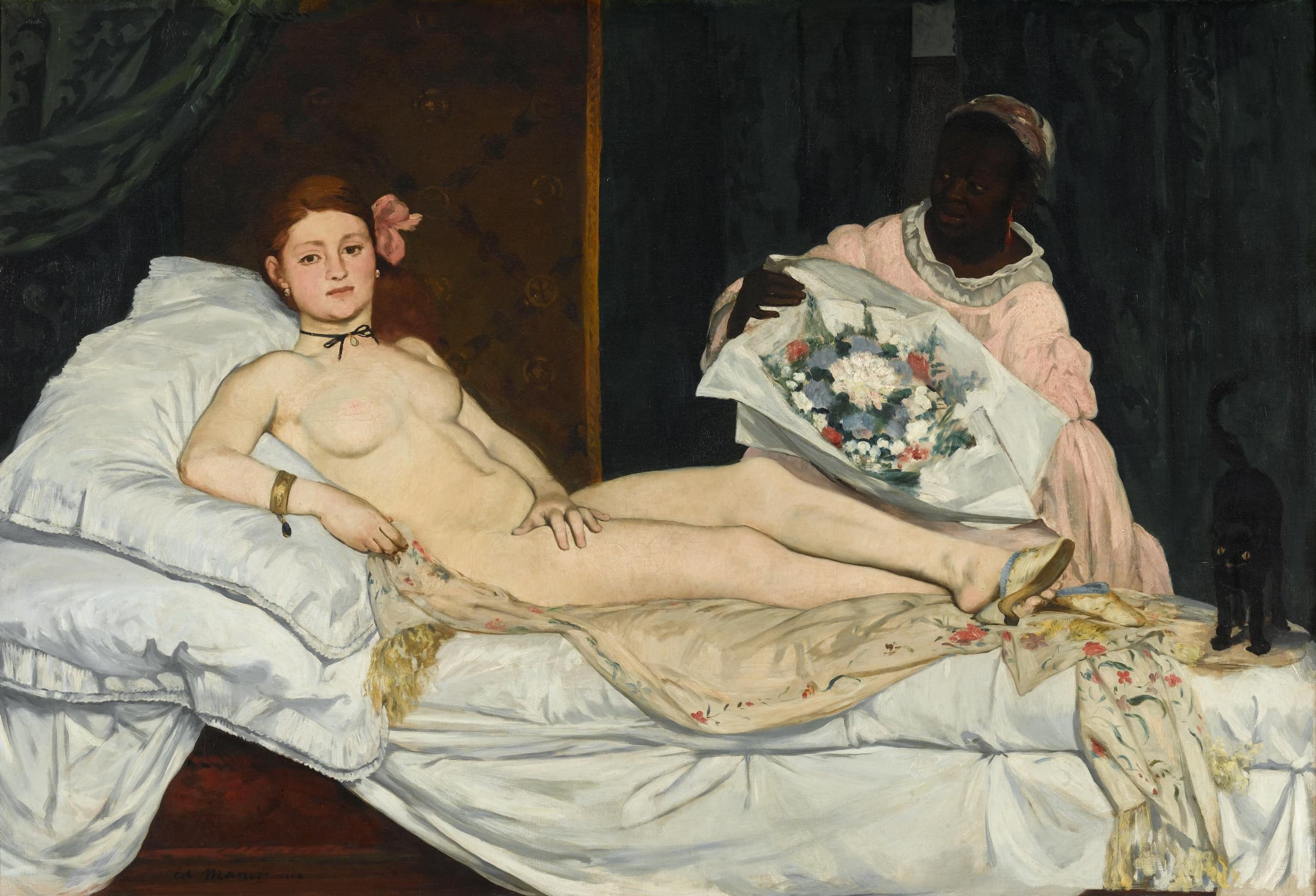 A nude woman reclines on white bedding across a wide canvas, looking straight out; a fully dressed Black maid stands beside her in a shallow interior.