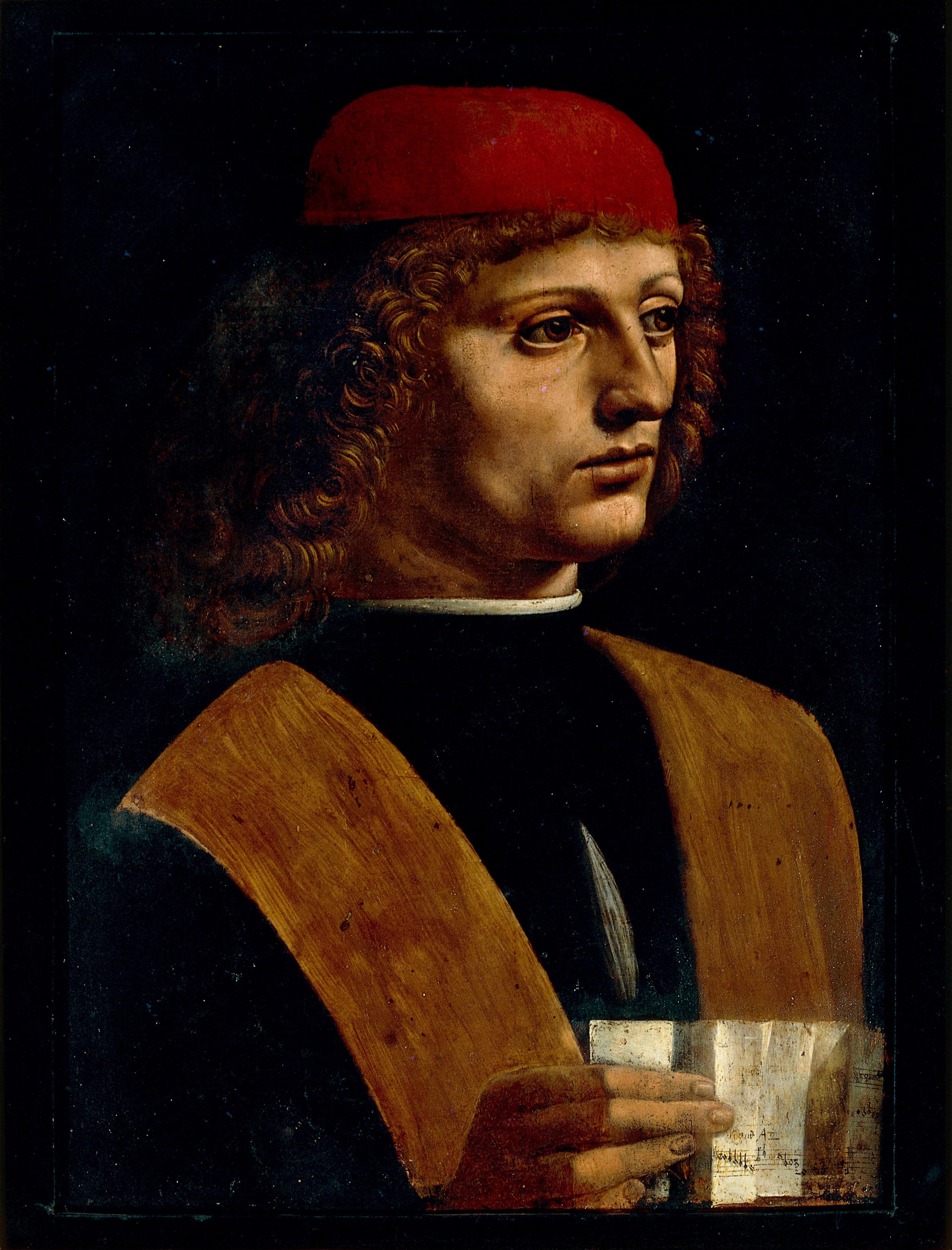 A half-length young man in a dark cap and garment against a plain dark ground, facing slightly aside; a hand in the lower part of the panel holds a folded sheet of music. The face is finely modelled; the torso is flatter and less finished.