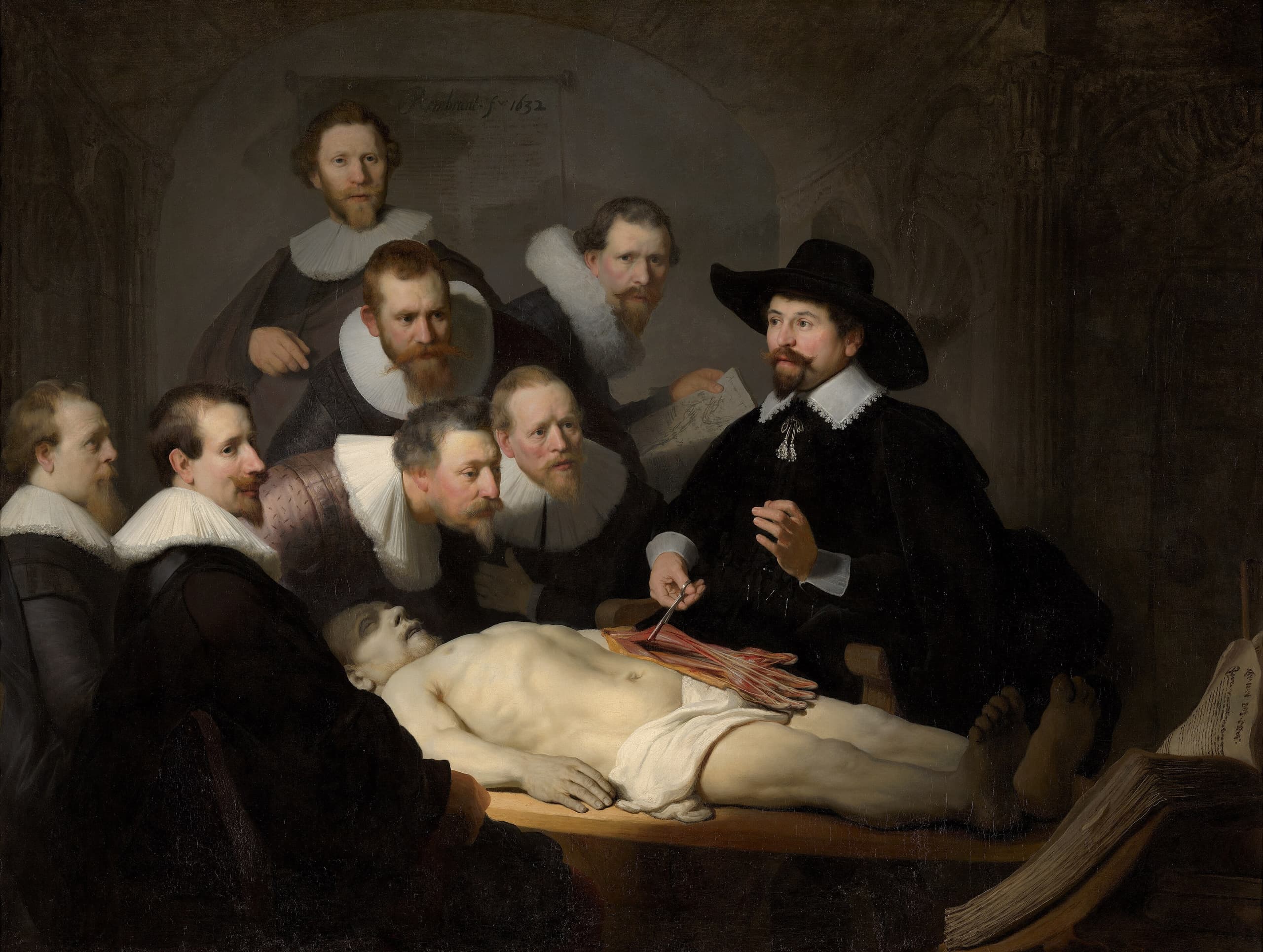 A dim interior where several bearded men in dark clothing cluster round a pale corpse. At the right a seated figure lifts the tendons of the dead man’s forearm with forceps while the others lean in or look out.