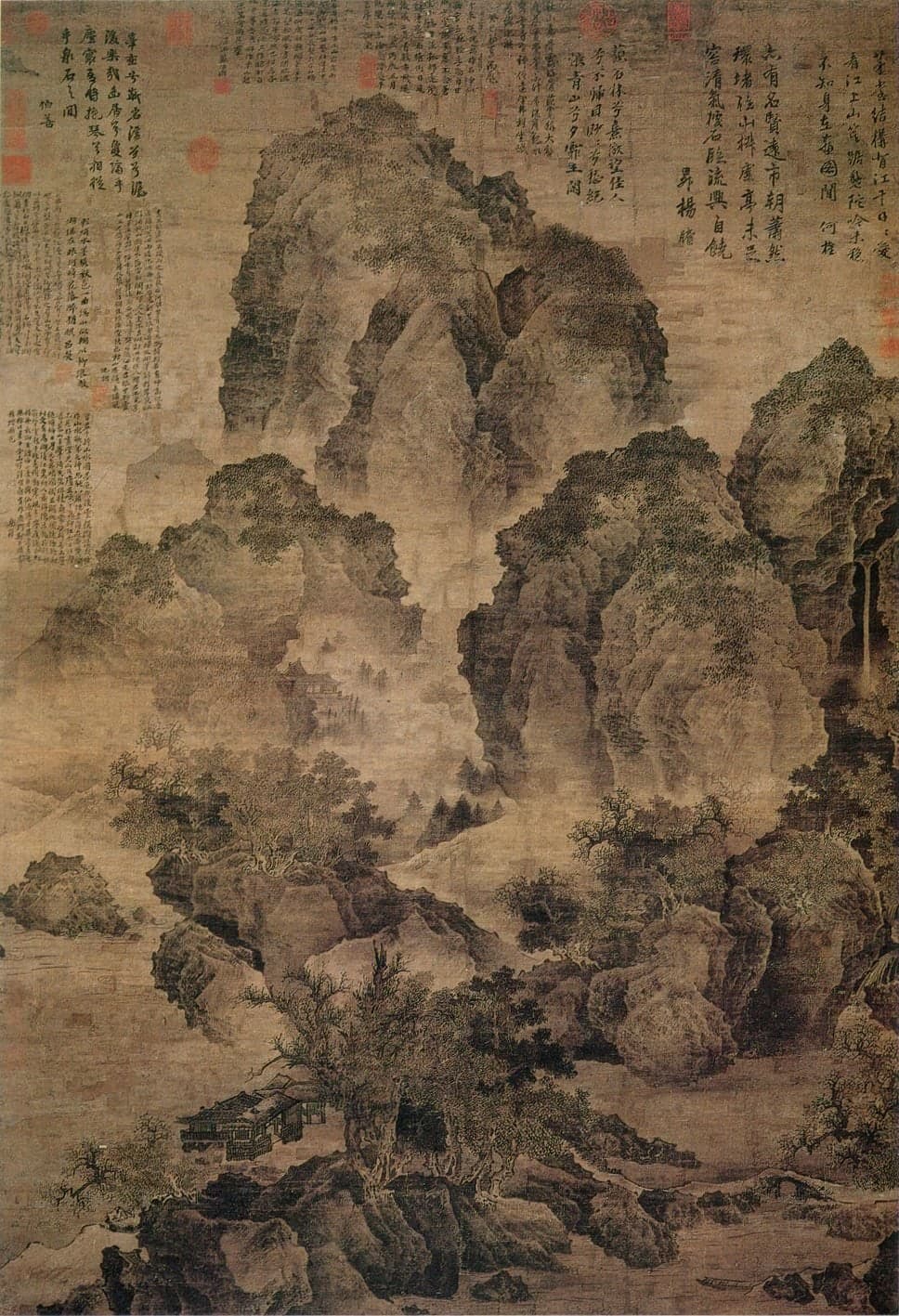 A tall silk landscape: a dark, towering cliff fills most of the height, with mist below it and a path among rocks and trees at the base, where a tiny mule train moves at the lower right.
