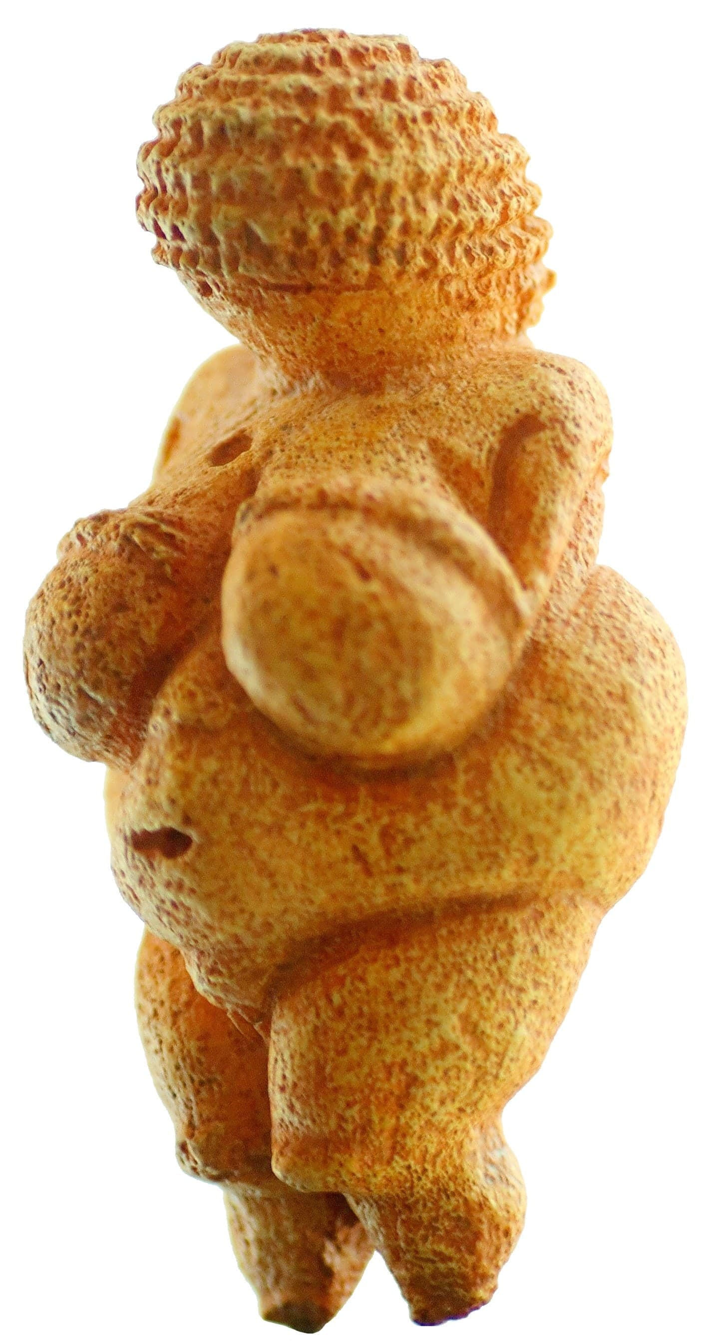 A small limestone figure with large breasts, rounded belly and wide hips. The head is covered in horizontal carved bands. No face is visible. The arms are thin lines. The legs taper to points.