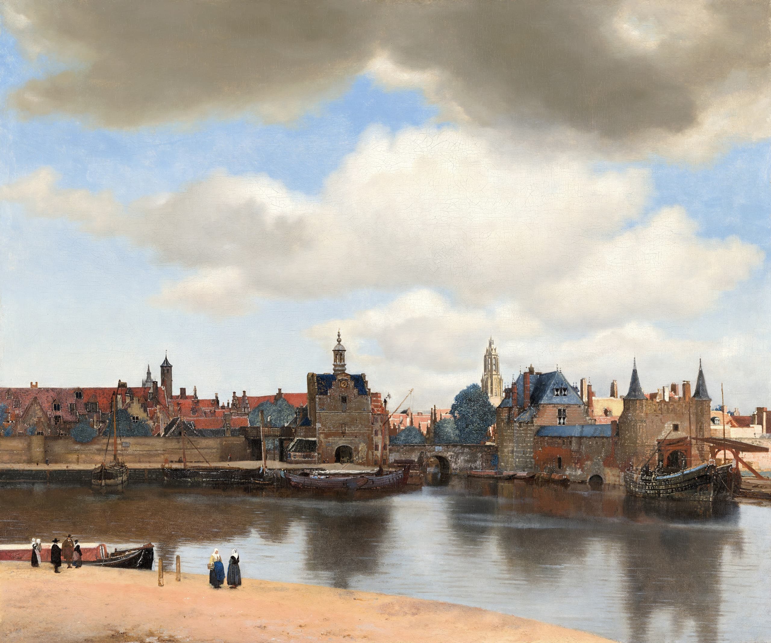 A wide town view: water and shore in the lower part, a horizontal band of brick buildings and roofs beyond, and a large cloudy sky filling the upper canvas. Light falls unevenly on the town.
