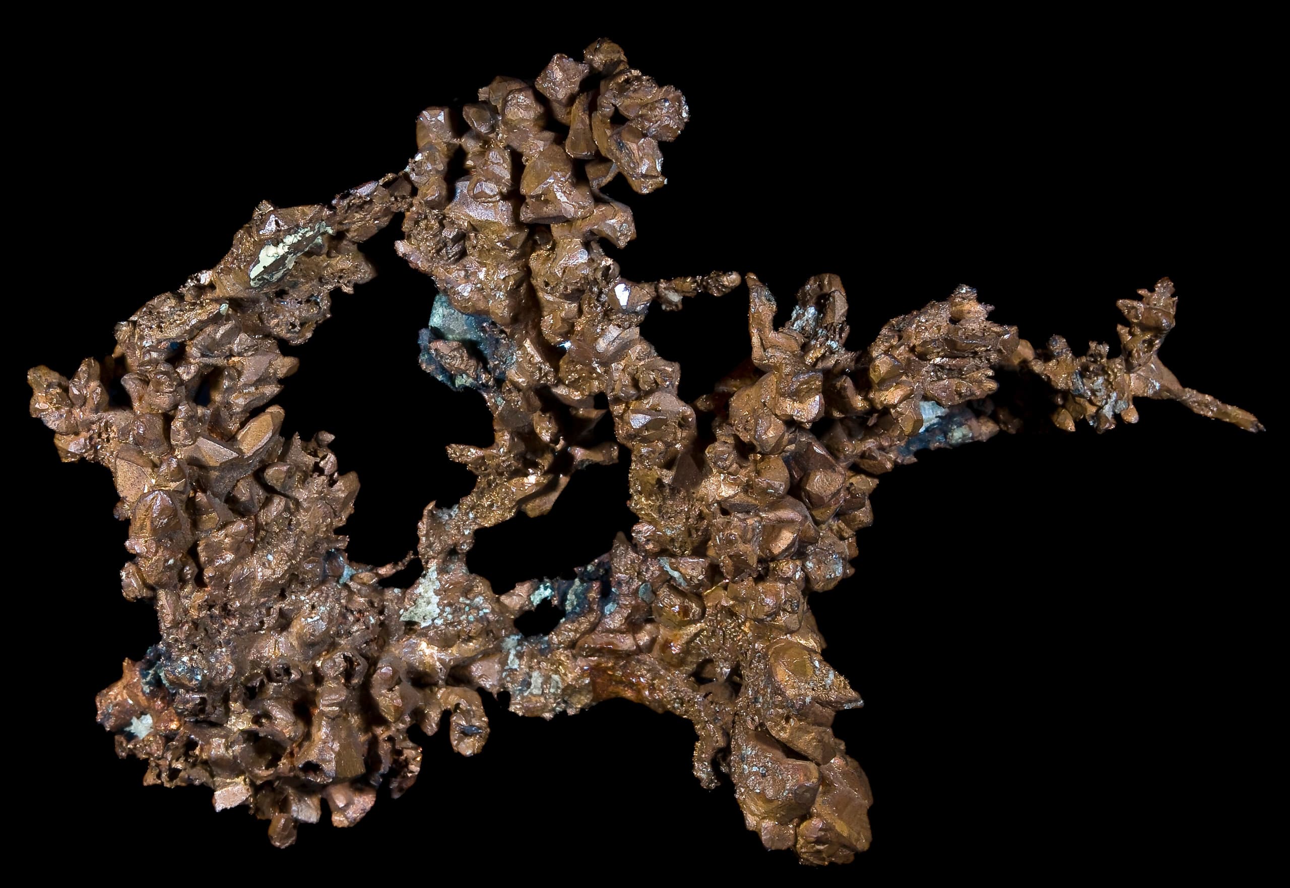 A reddish-orange metallic element with a pinkish hue on a freshly exposed surface.
