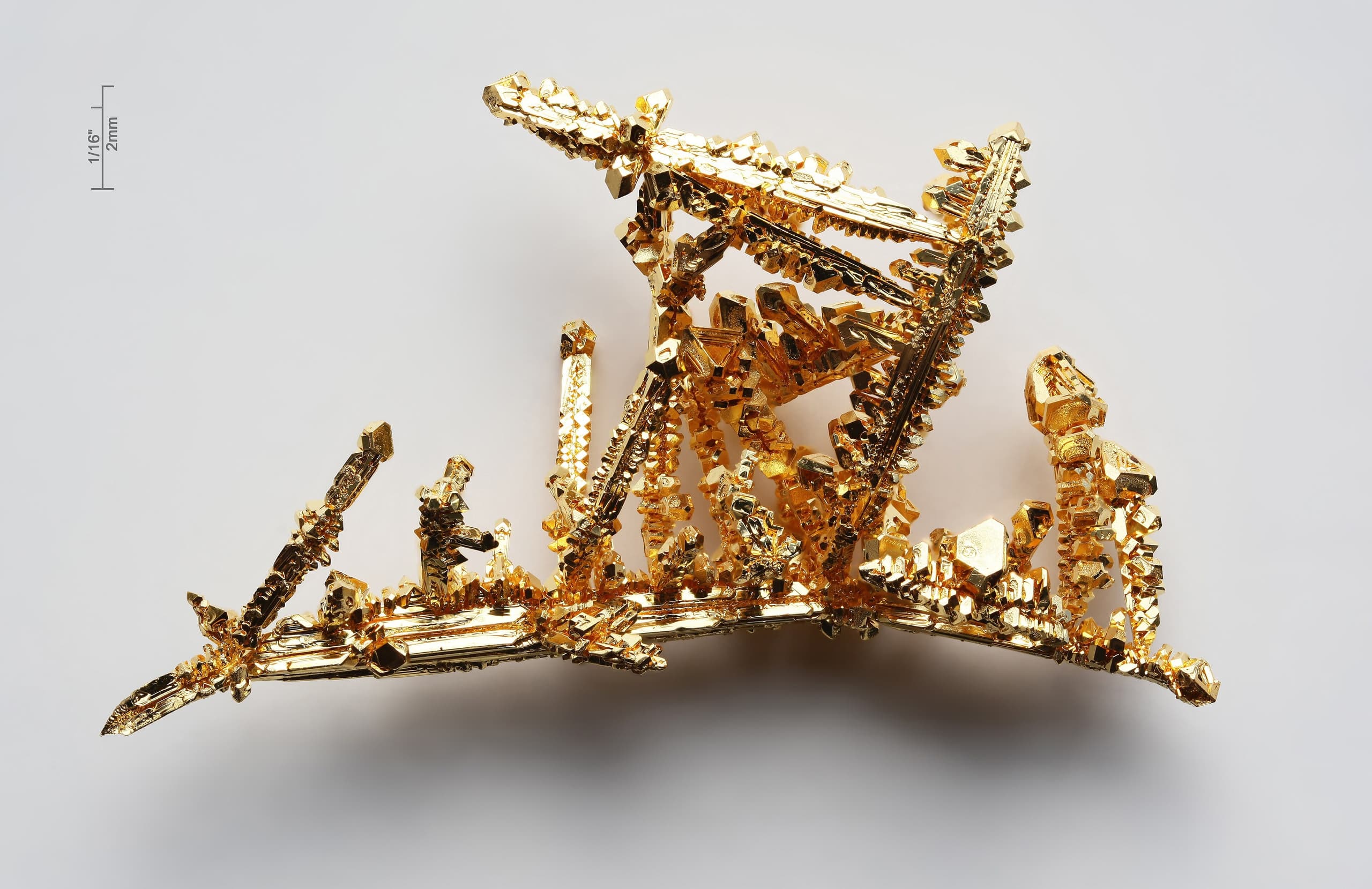A bright metallic yellow, dense metal in its pure form, shown as a polished surface or sample.