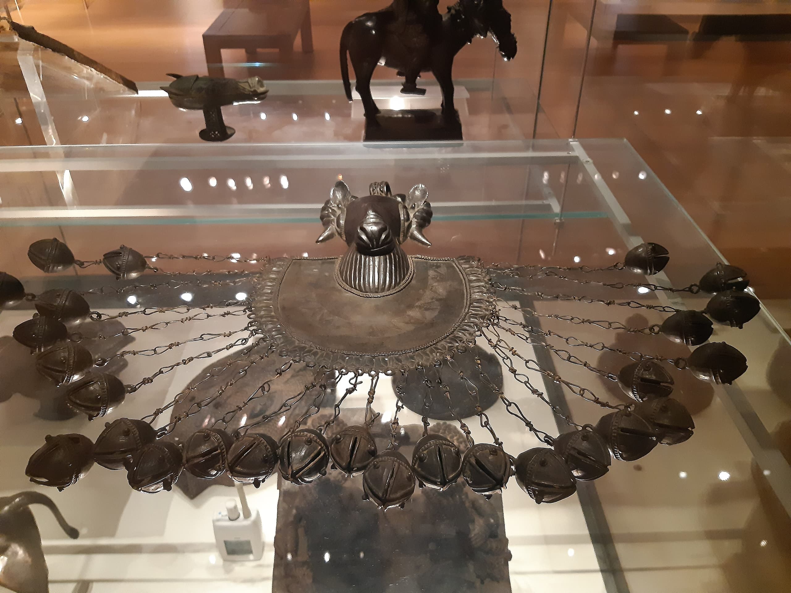 A collection of intricate bronze jewelry including pectorals with detailed designs