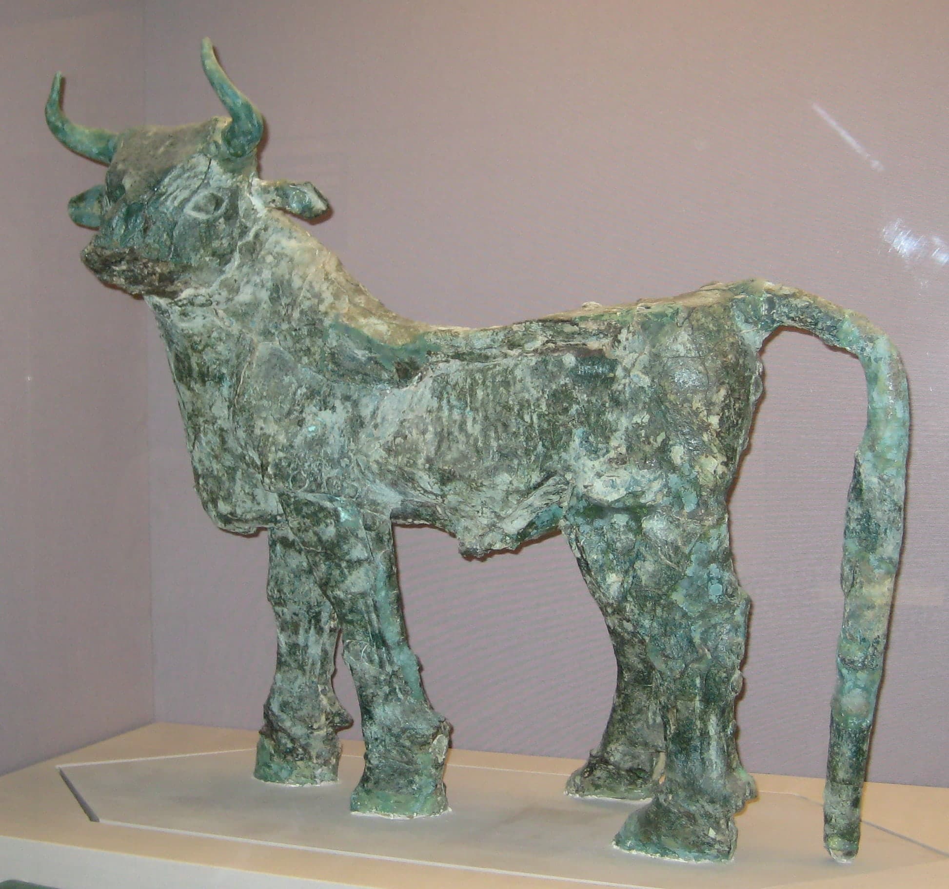 A copper sculpture of a bull, the animal’s body and head modelled in metal, shown as a freestanding figure from the British Museum collection.