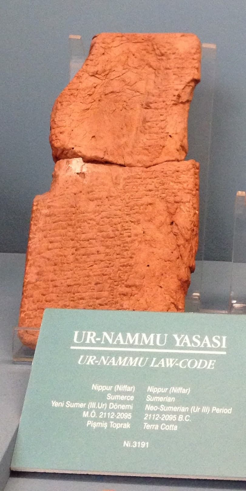 Clay tablets incised with cuneiform script in columns, the wedge-shaped marks pressed into the surface in regular rows.