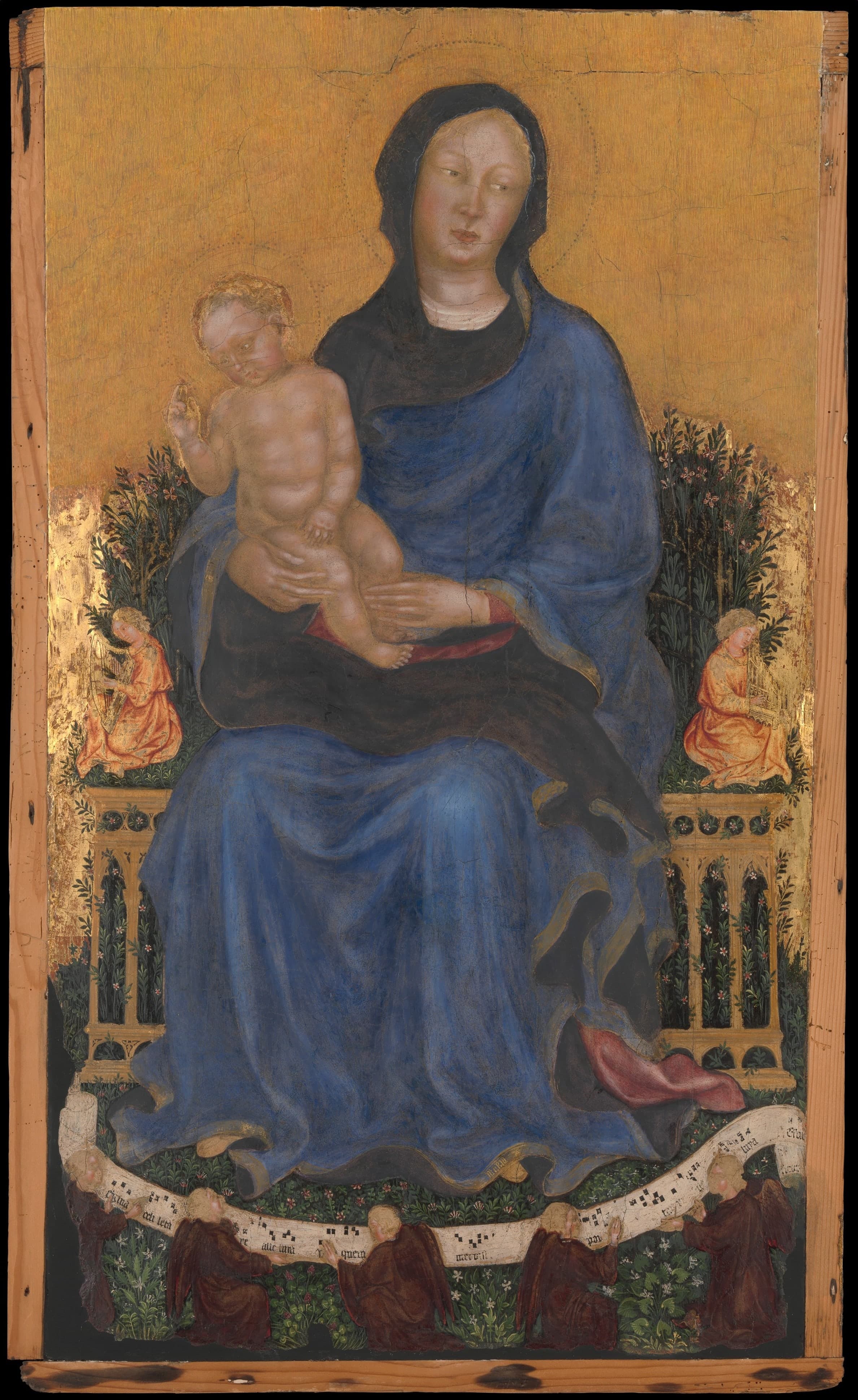 A tall, narrow panel in tempera and gold, painted with the Madonna and Child accompanied by angels, in a refined International Gothic manner.