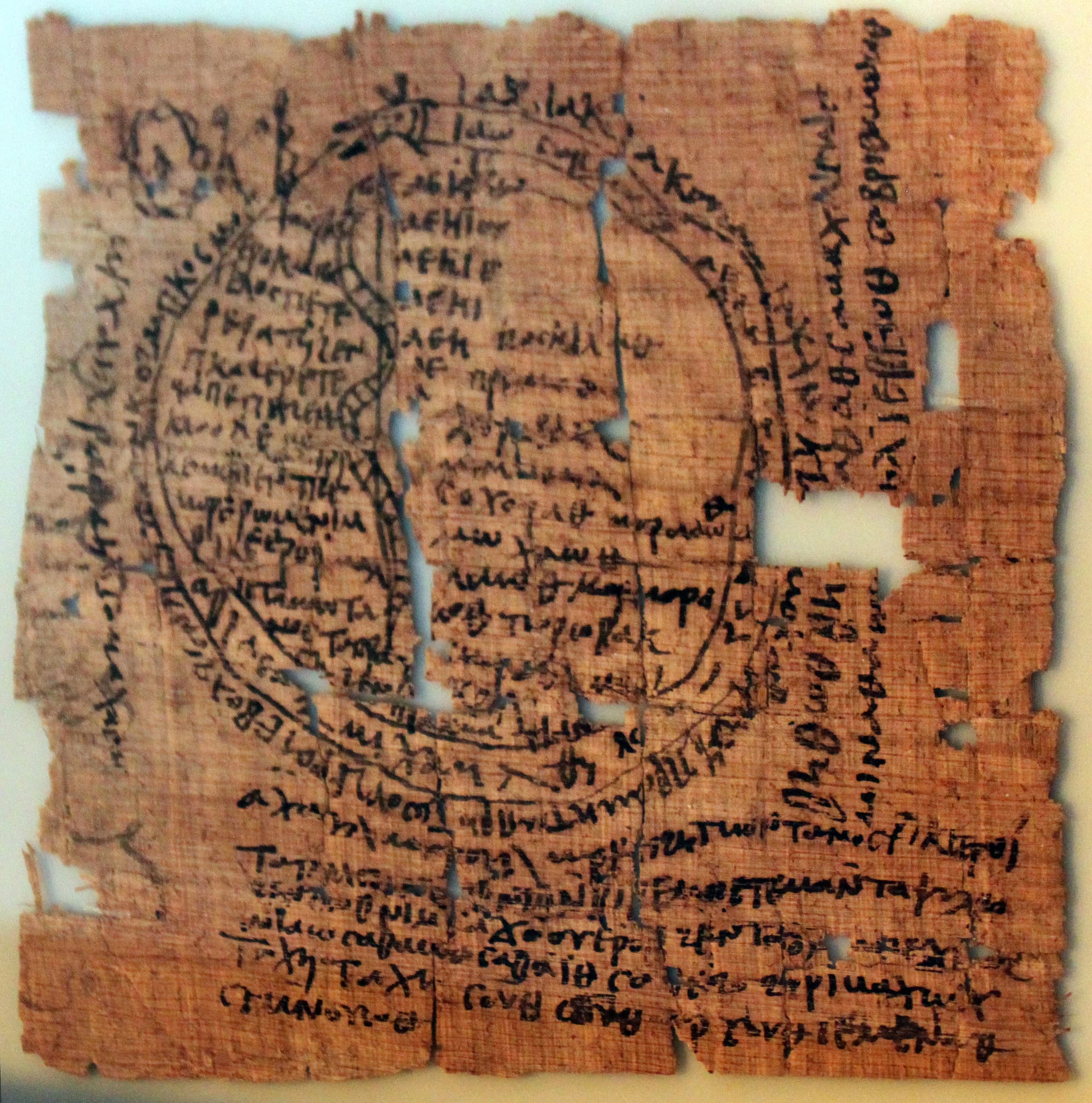 A fragment of woven linen with coloured wool decoration showing figures, geometric patterns, or Christian motifs typical of Coptic Egyptian textiles.