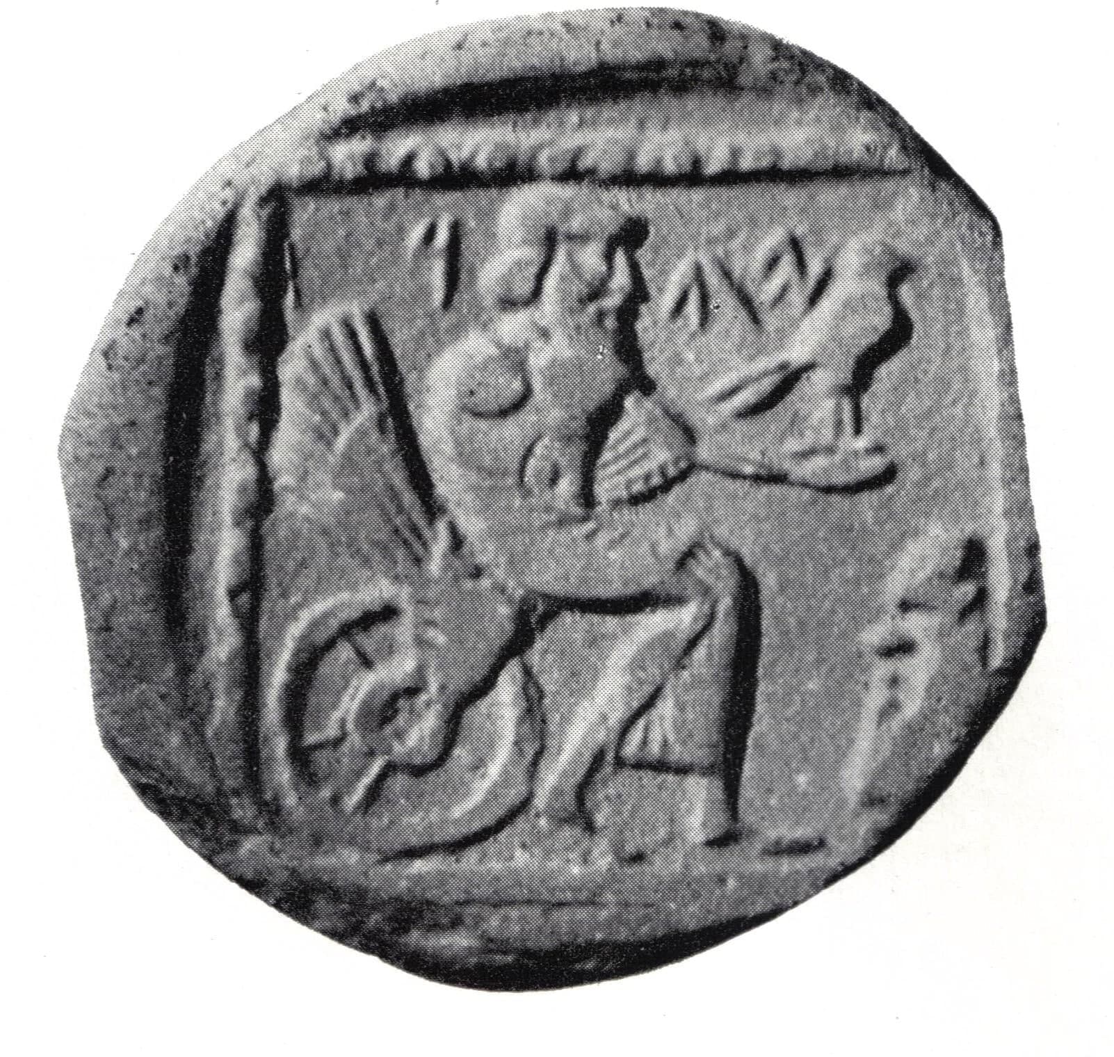 A small silver coin, about fifteen millimetres across, showing a seated deity on a wheeled device with wings, struck on a compact round flan.