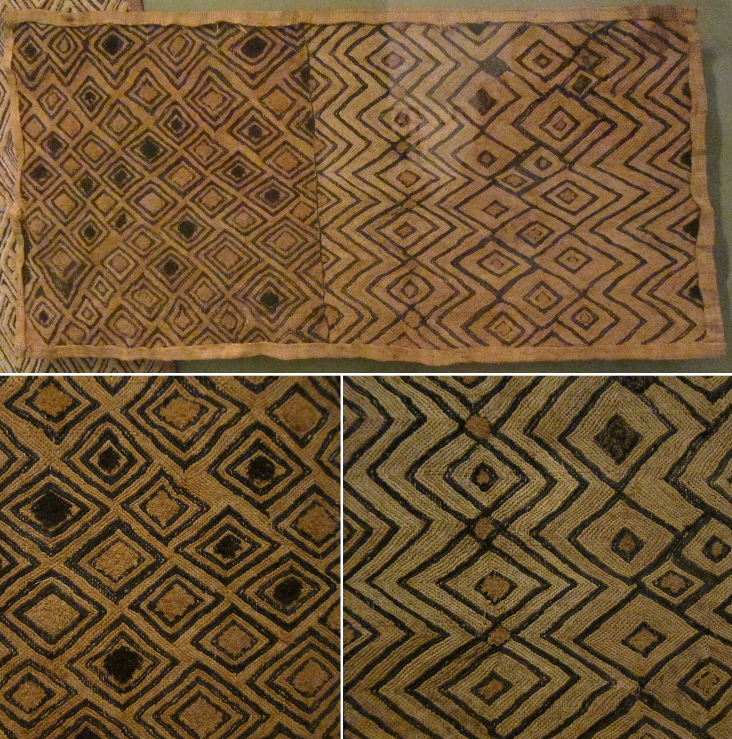 A rectangular panel of woven raffia palm fibre, densely embroidered with geometric patterns in contrasting thread, some areas cut into a short pile that creates texture and shifts the way light falls across the surface.