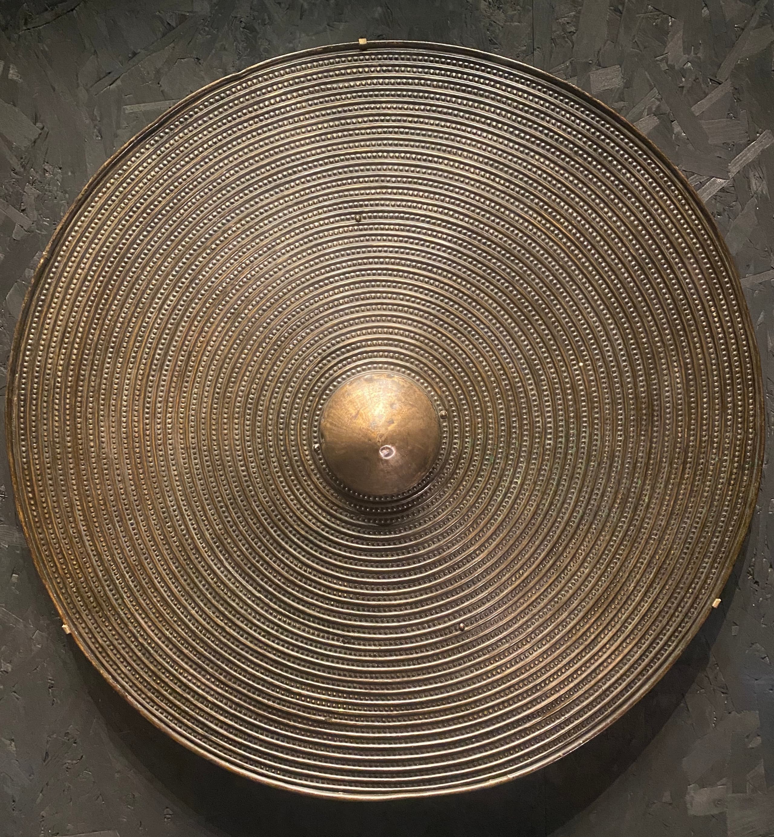 A large copper-alloy shield of Yetholm type, recorded from Moel Hebog and held by the British Museum; fine surface detail is not described in the sources used here.