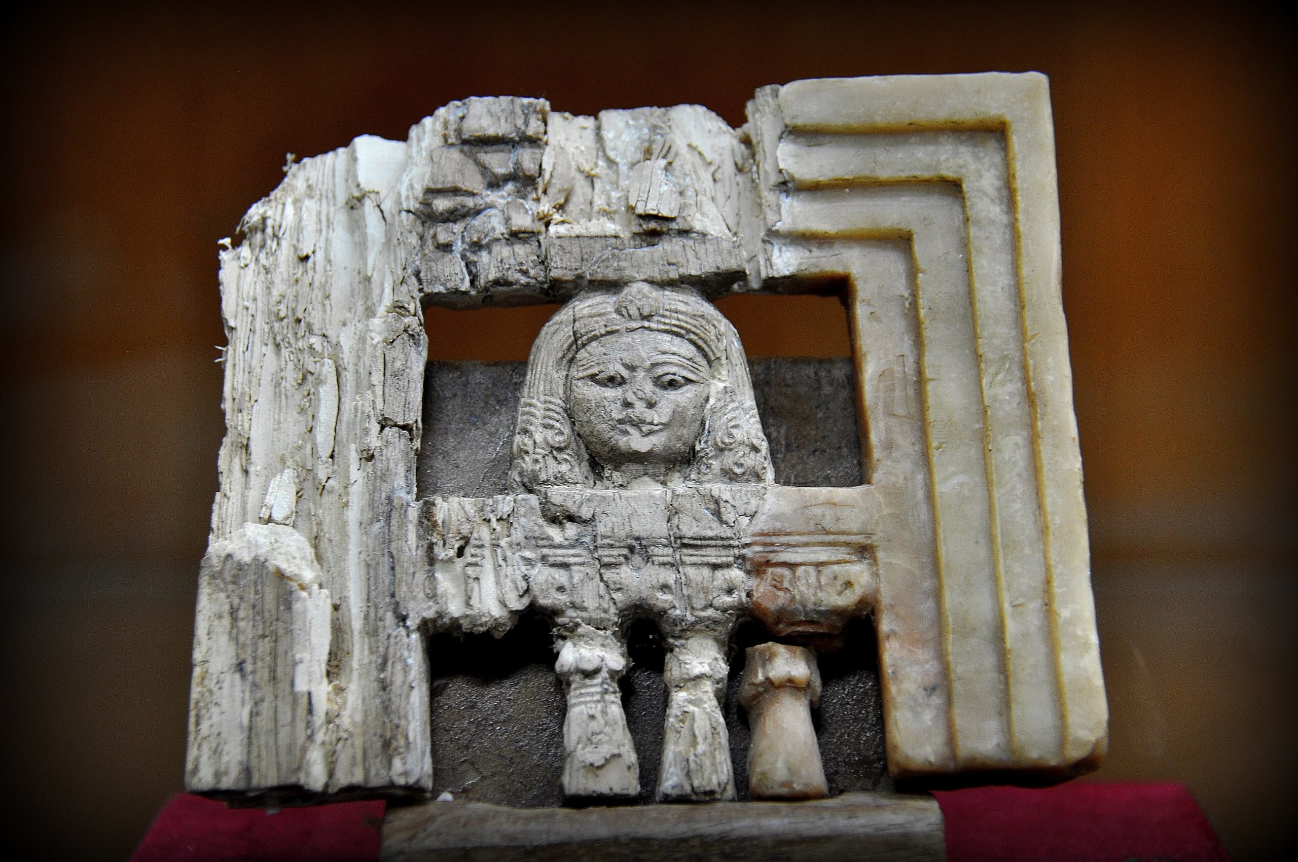 Small carved ivory plaques, some fragmentary, decorated with figures, animals, and floral motifs in low relief, displayed against a neutral background.