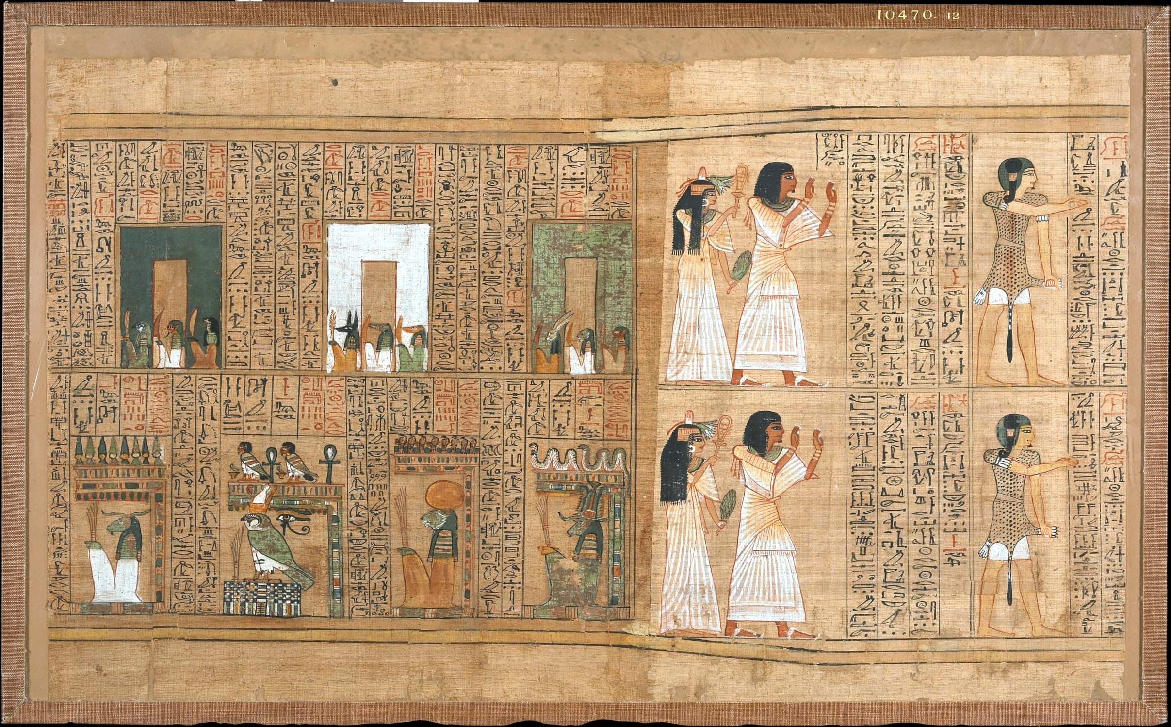 A wide sheet of ancient papyrus filled with rows of cursive hieroglyphs and colour-painted figures, denser in text than in open space.