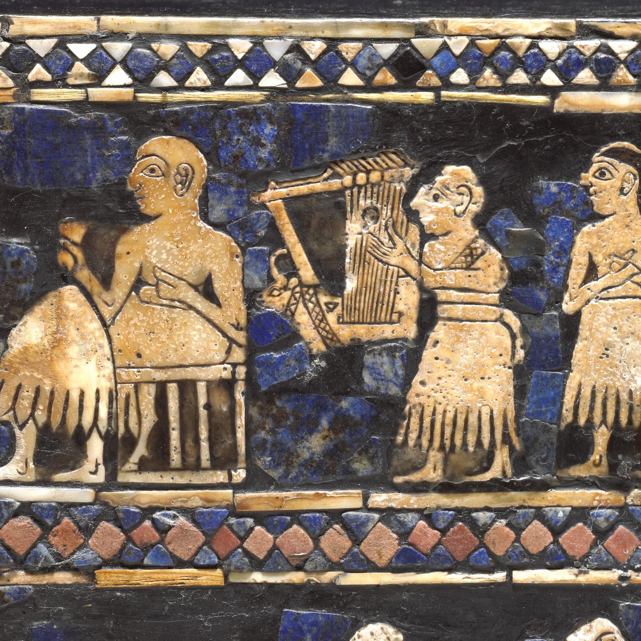 A reconstructed wooden lyre with a gold-covered soundbox fronted by a bull's head in gold and lapis lazuli, and a rectangular inlay panel below showing animals in human postures.