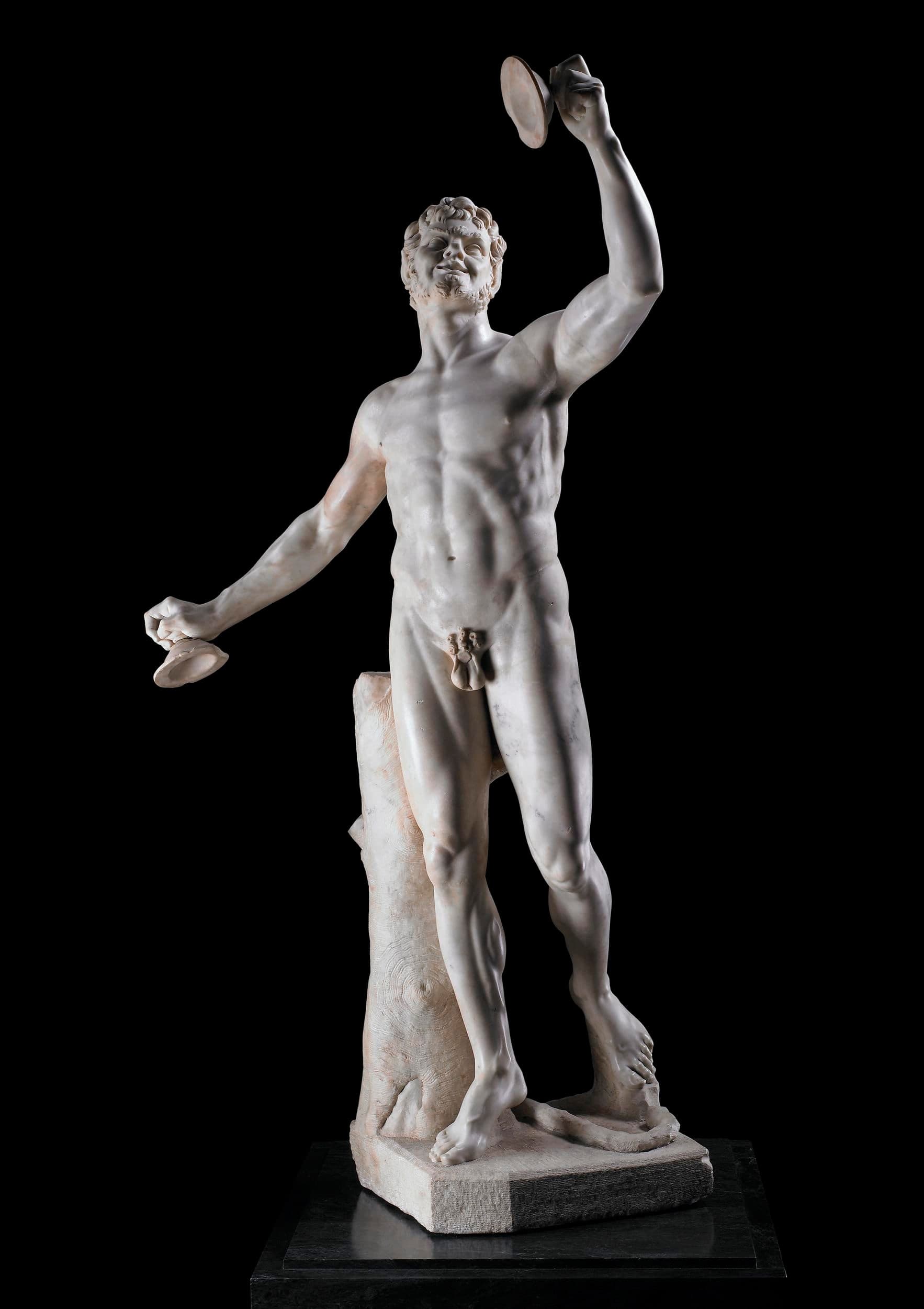 A life-sized marble statue of a faun, shown as a complete standing figure with an ancient torso said to have been supplemented by later sculptural additions.