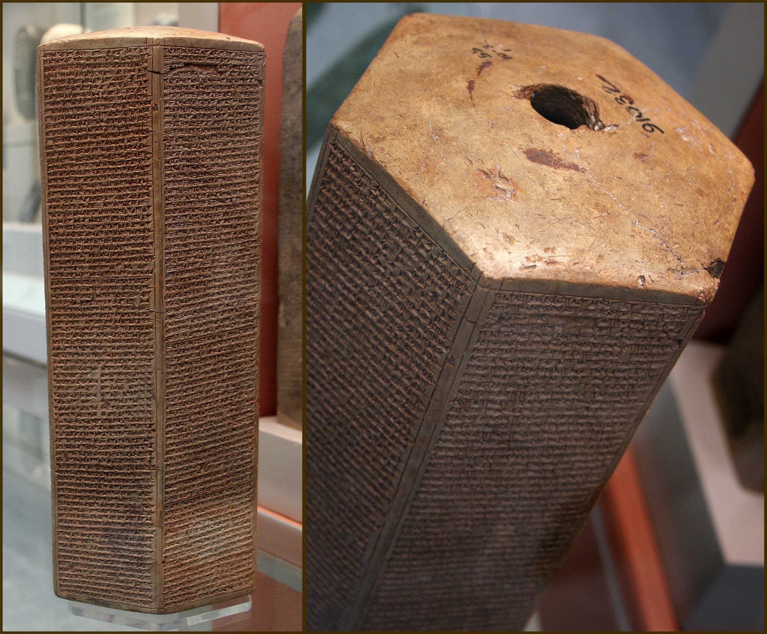 A tall, narrow clay prism densely covered on its faces with tightly packed lines of cuneiform inscription, the surface a muted brown-grey.