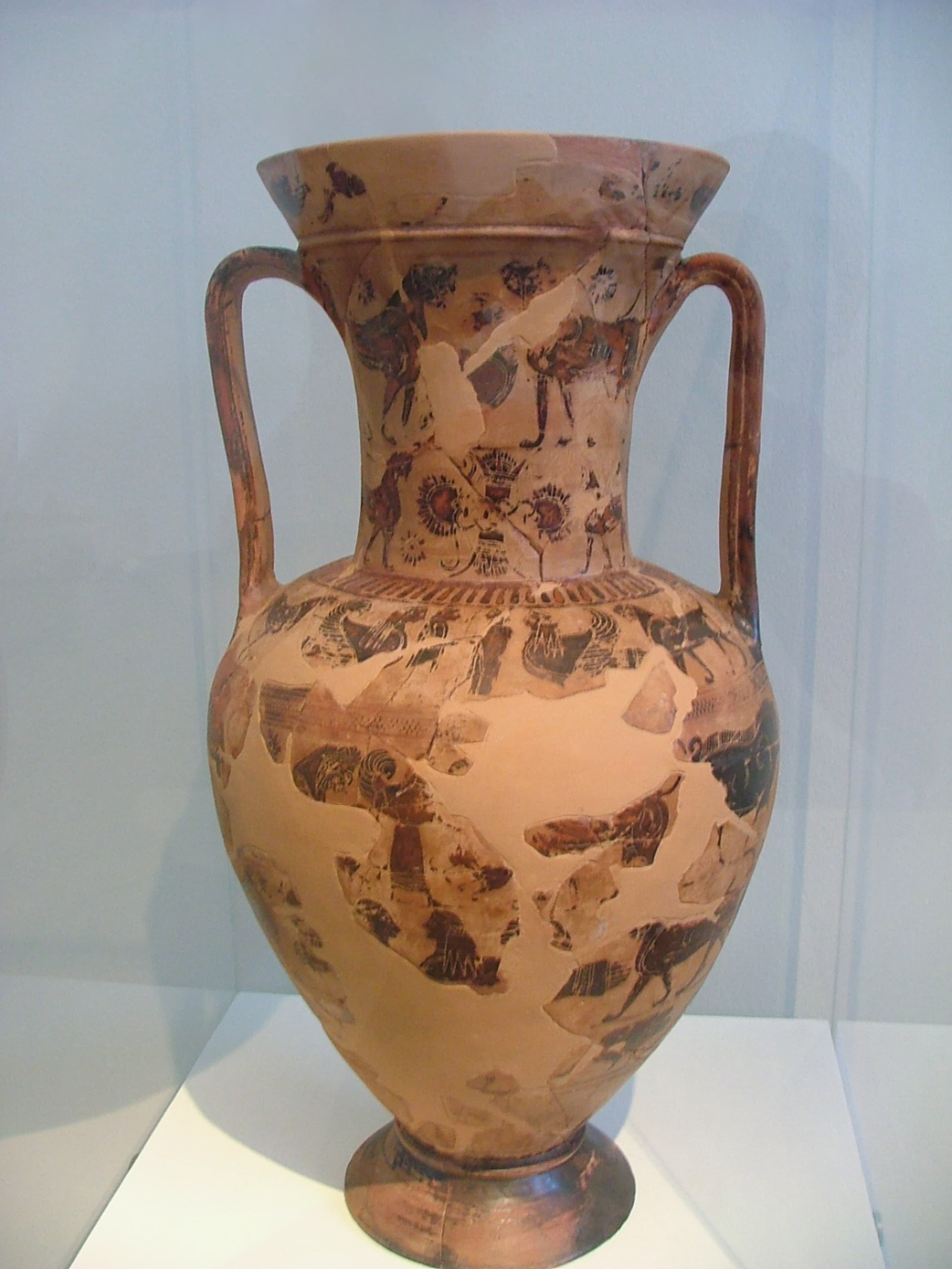 A large ceramic wine basin with a rounded body, painted in black-figure technique with a mythological procession encircling the vessel, and inscribed with the name Sophilos in Greek letters.
