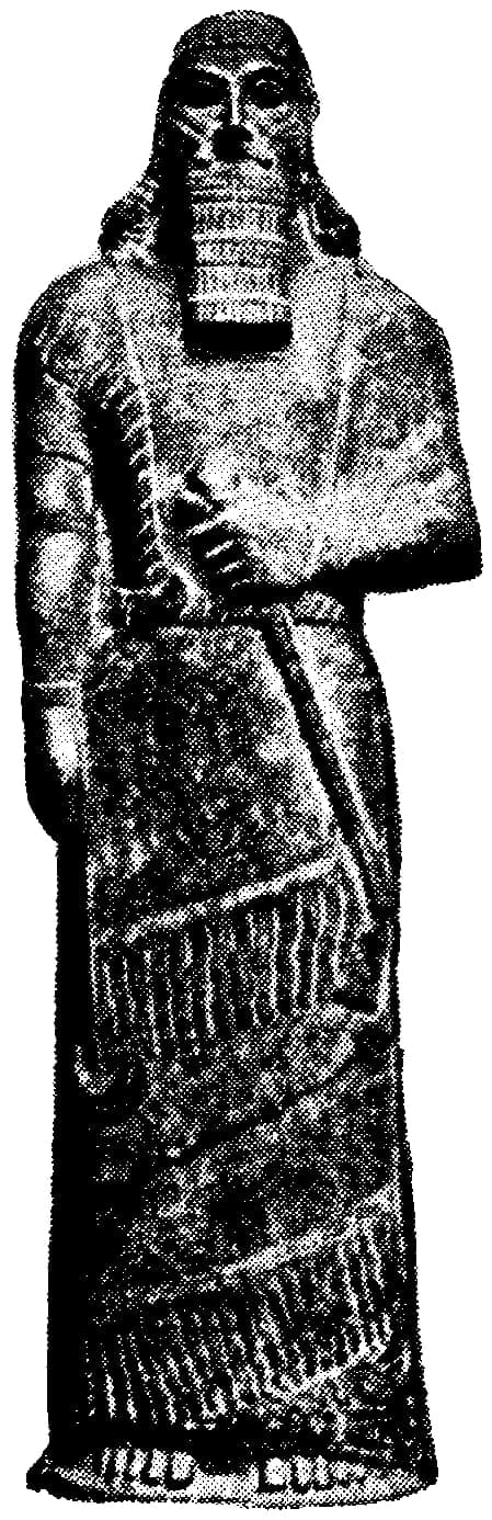 A pale magnesite standing figure of a man, 113 centimetres (3 ft 8 in) high, carved fully in the round, narrow in depth, with a calm frontal stance.