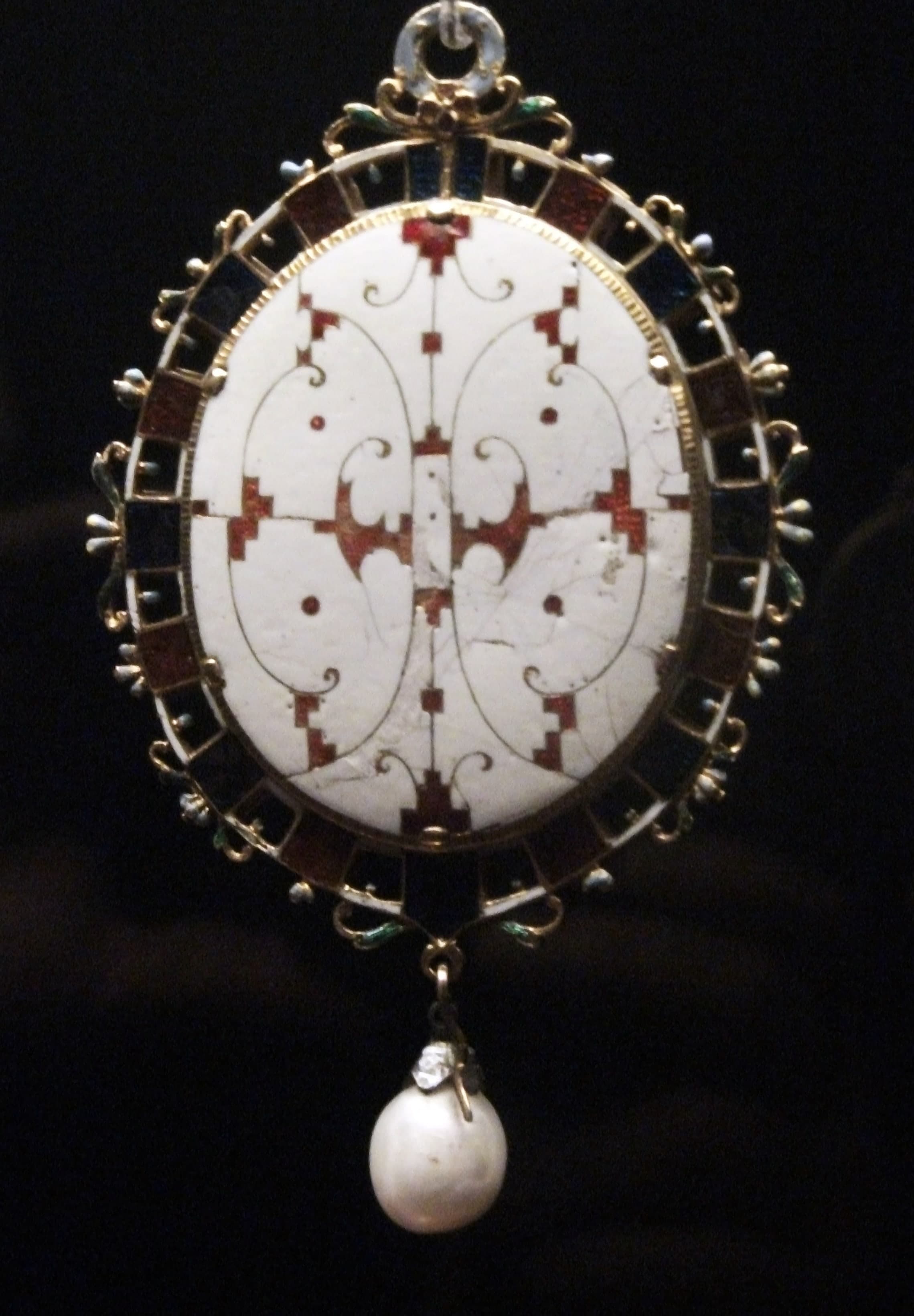 A small gold locket set with diamonds and coloured vitreous enamel, made to hold a miniature painted on vellum.