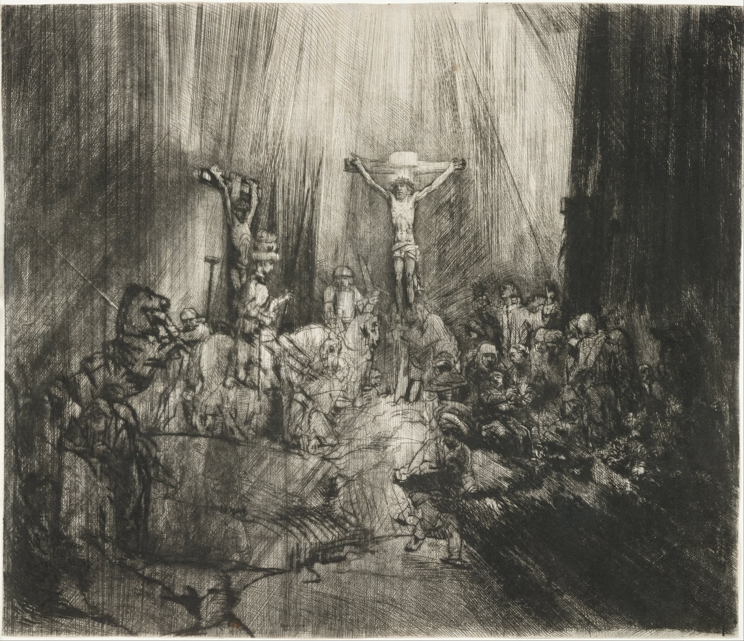 A dense black-and-white Crucifixion scene: three crosses rise above a crowd of mourners and mounted figures, while a pale shaft of light falls through a dark sky.