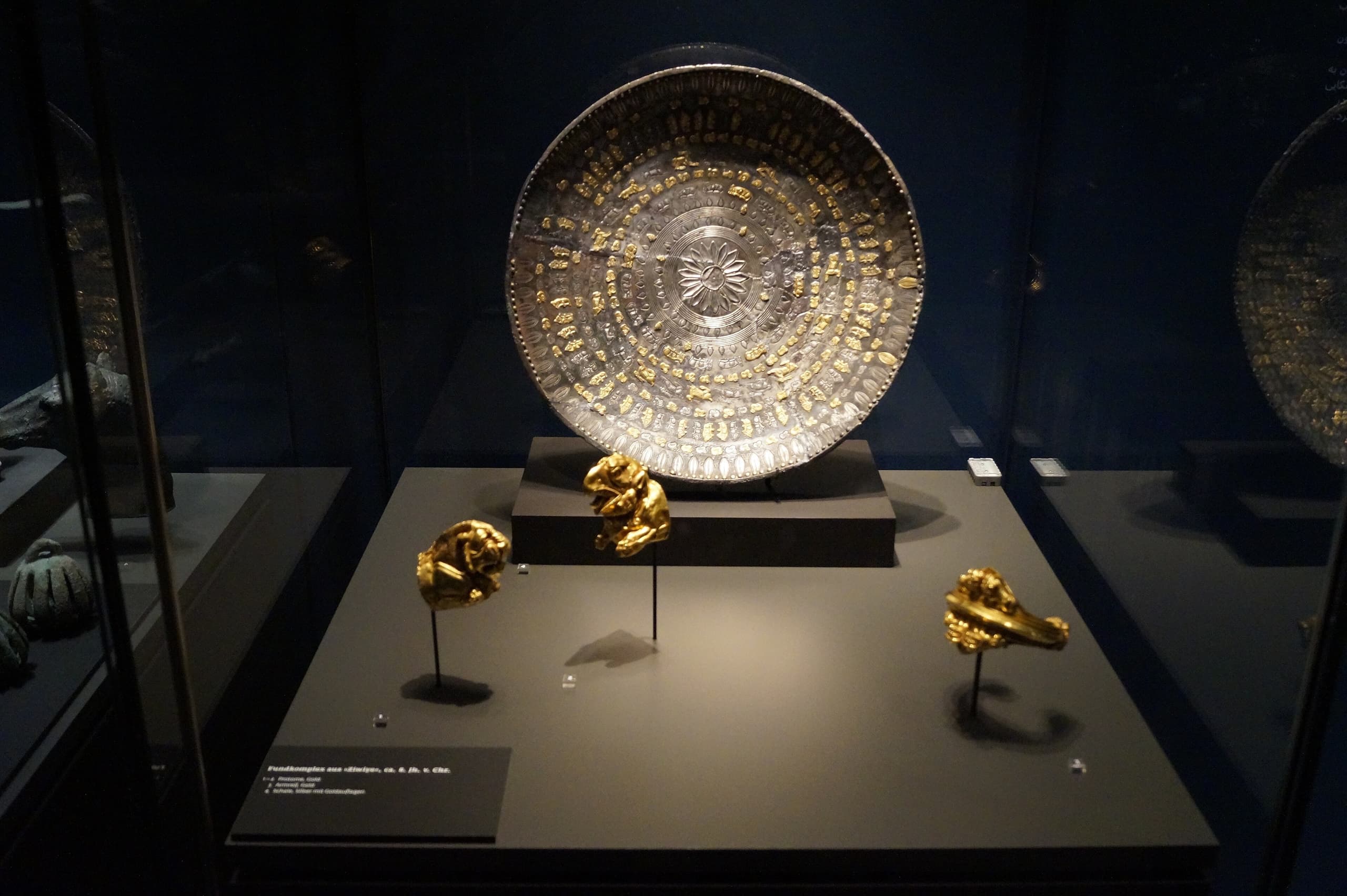 Worked gold, silver and ivory from a hoard, including small gold pieces formed as human faces, linked to the Ziwiye find near Saqqez.